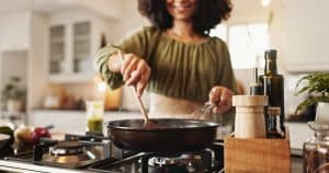 Hands-woman-and-pan-on-stove-for-cooking-food-he-2026-01-09-10-00-26-utc